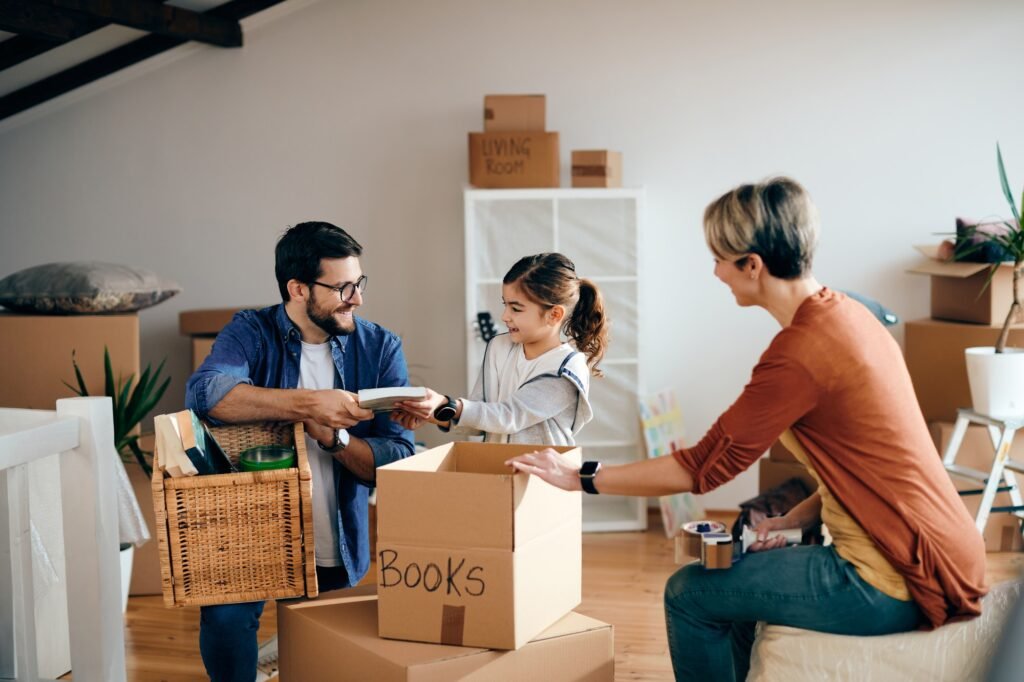 Happy family having fun while unpacking their belongings in a new apartment.
